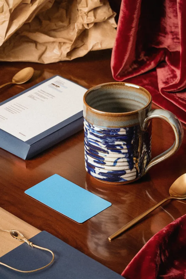 Cards on the table with various objects including wine glass, dice, and playing cards