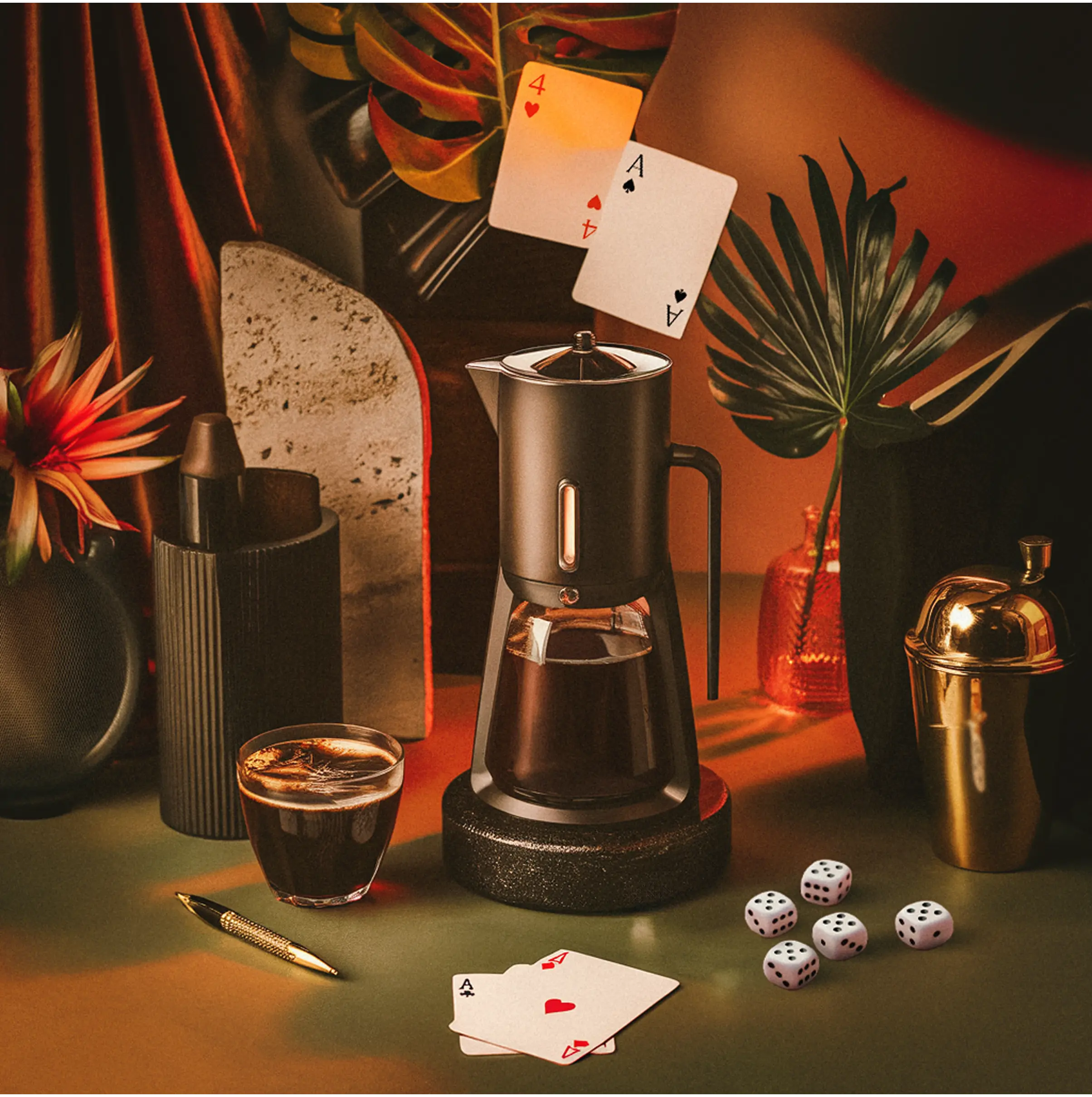 A workspace scene with cards and dice beside a coffee maker